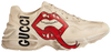 Gucci Wmns Rhyton sneaker in ivory leather with red mouth print graphic and chunky sole.

