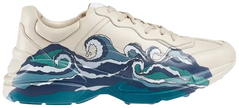 Gucci Wmns Rhyton 'Wave' ivory leather sneaker with blue retro wave graphic and chunky sole.

