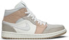 Air Jordan 1 Mid 'Milan' sneaker featuring beige suede and leather upper with MLN hangtag and Air cushioning.