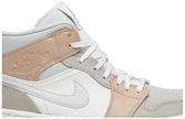 Air Jordan 1 Mid 'Milan' sneaker featuring beige suede and leather upper with MLN hangtag and Air cushioning.