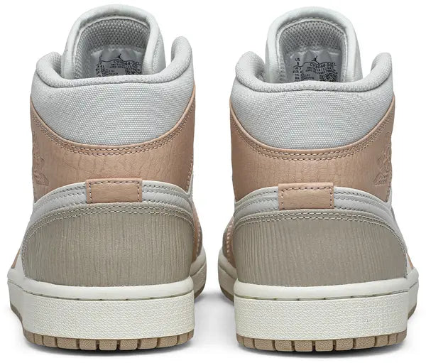 Air Jordan 1 Mid 'Milan' sneaker featuring beige suede and leather upper with MLN hangtag and Air cushioning.