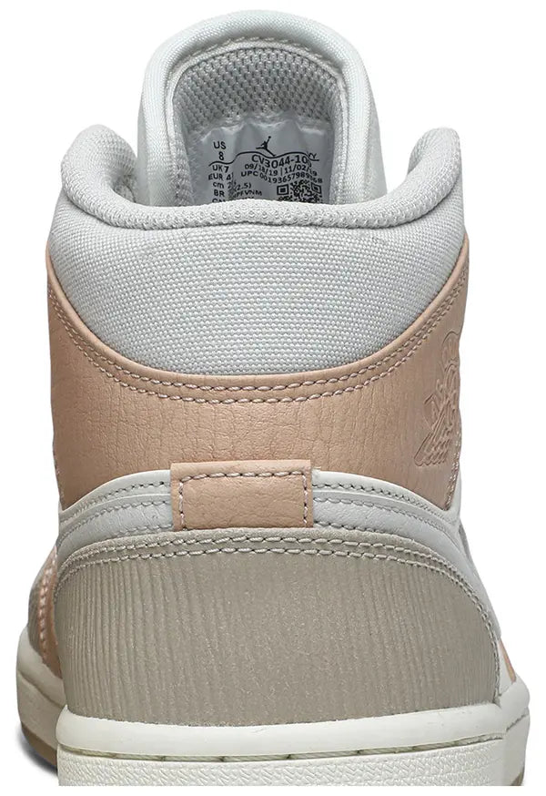 Air Jordan 1 Mid 'Milan' sneaker featuring beige suede and leather upper with MLN hangtag and Air cushioning.