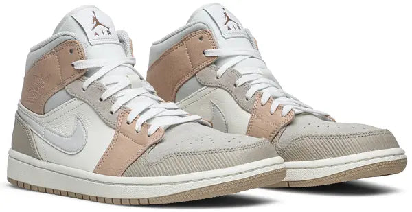 Air Jordan 1 Mid 'Milan' sneaker featuring beige suede and leather upper with MLN hangtag and Air cushioning.