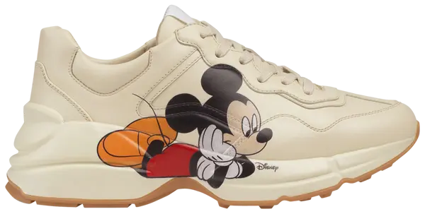 Disney x Gucci women’s Rhyton sneaker in ivory leather with Mickey Mouse print and chunky rubber sole.

