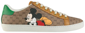 Disney x Gucci Women’s Ace sneaker in beige GG Supreme canvas with Mickey Mouse graphic and green-red Web stripe.