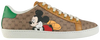 Disney x Gucci Women’s Ace sneaker in beige GG Supreme canvas with Mickey Mouse graphic and green-red Web stripe.