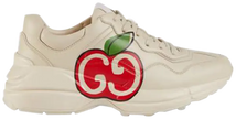 aGucci Wmns Rhyton sneaker in ivory leather featuring red GG Apple motif and thick rubber sole.


