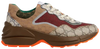 Gucci Wmns GG Rhyton sneaker in beige GG Supreme canvas with brick red Gucci logo and thick vintage-style rubber sole.

