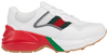 Gucci Women's Rhyton sneaker in white mesh with red and green webbing and reflective detailing on a thick off-white sole.

