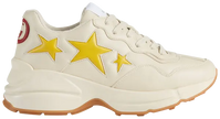 Gucci Wmns Rhyton 'Stars' sneaker featuring yellow star graphics on white vegan leather upper with ivory accents.

