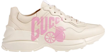 Gucci Wmns Rhyton 'Lemon Gucci' sneaker in cream leather with Lemon Gucci graphic on side.

