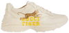 Gucci Wmns Rhyton 'Gucci Tiger' sneaker featuring retro tiger print on ivory leather upper with chunky sole.

