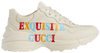 Gucci Wmns Rhyton 'Exquisite Gucci - Ivory' sneaker with bold text graphic on ivory leather and oversized sole.

