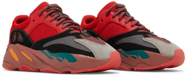 Yeezy Boost 700 ‘Hi-Res Red’ sneaker with red mesh and suede upper, maroon Boost midsole, and multicolor accents.