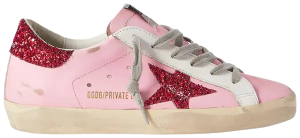 Golden Goose Superstar orchid pink glitter sneaker with distressed leather and red heel tab.