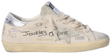 Golden Goose women's Superstar sneaker in white leather with grey suede star and silver heel tab, distressed sole design.

