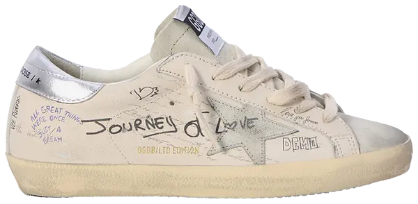 Golden Goose women's Superstar sneaker in white leather with grey suede star and silver heel tab, distressed sole design.

