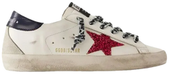 Golden Goose women's Superstar sneaker in white leather with blue glitter star, pink heel tab, and distressed vintage sole.