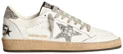 Golden Goose Ball Star women’s sneaker in white leather with silver glitter star and metallic heel, featuring vintage-style distressed sole.

