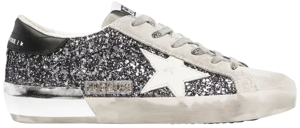 Golden Goose Wmns Superstar sneaker in silver glitter with black star and grey suede accents, distressed finish.