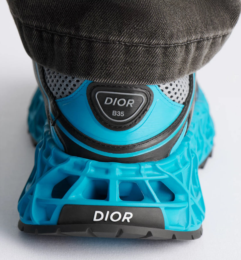 Blue Dior sneaker with textured sole on a white background